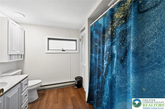 a bathroom with a toilet and a shower