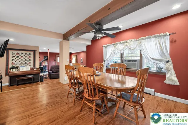 a dining room with furniture window and wooden floor