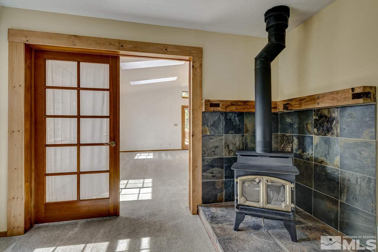 15920 Toll Road Reno, NV 89521 - Photo 15 of 24 a living room with a fireplace furniture and a large window