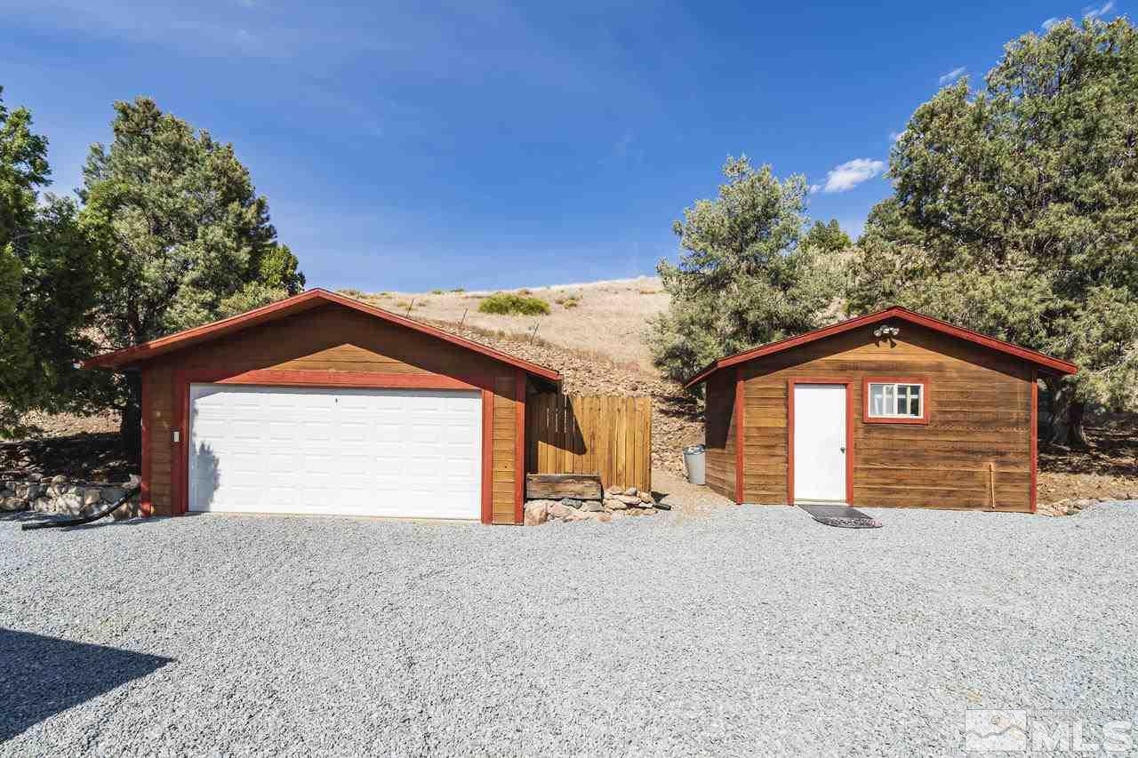15920 Toll Road Reno, NV 89521 - Photo 2 of 24 a front view of a house with a yard and garage