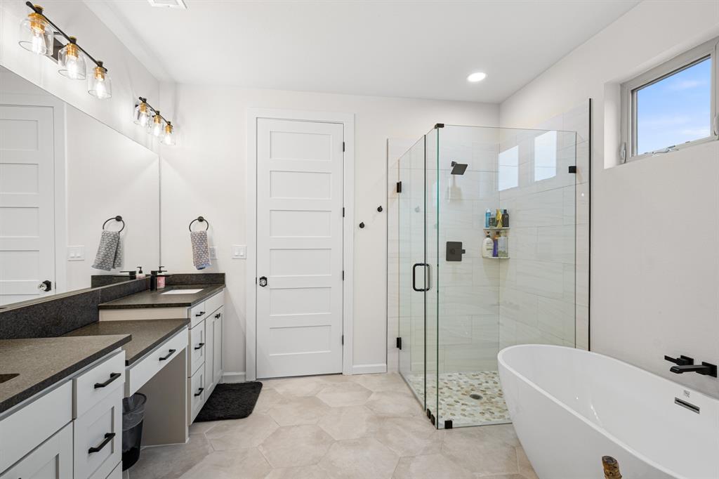 476 Silverleaf Drive Sunset, TX 76270 - Photo 12 of 40 a bathroom with a granite countertop sink a toilet a mirror and shower