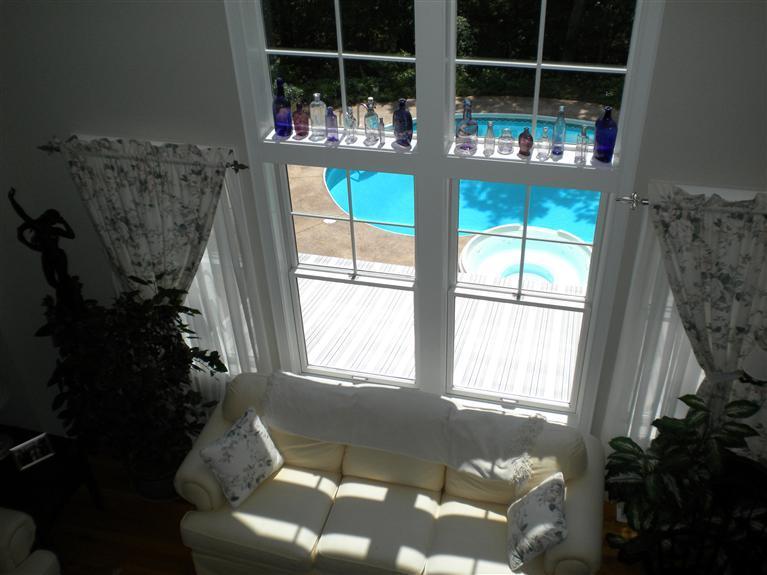 146 Cairn Ridge Road East Falmouth, MA 02536 - Photo 17 of 29 a living room with furniture and a floor to ceiling window