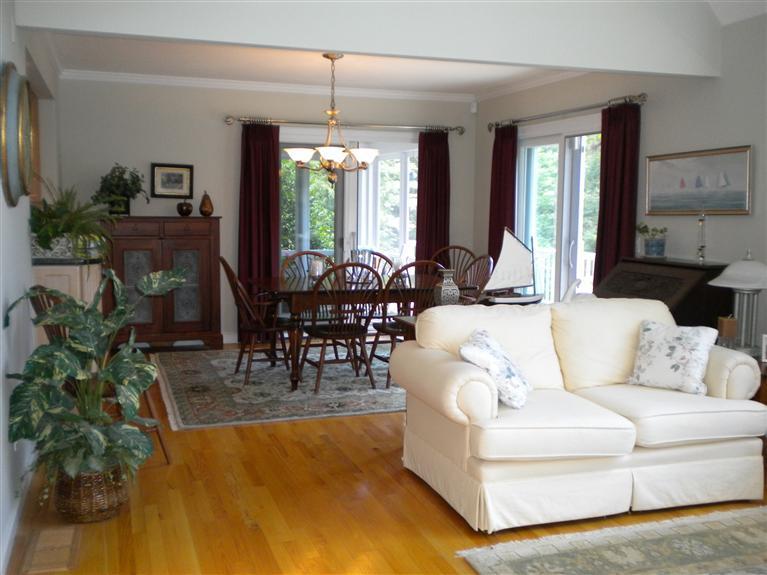146 Cairn Ridge Road East Falmouth, MA 02536 - Photo 7 of 29 a living room with furniture potted plant a chandelier and a flat screen tv