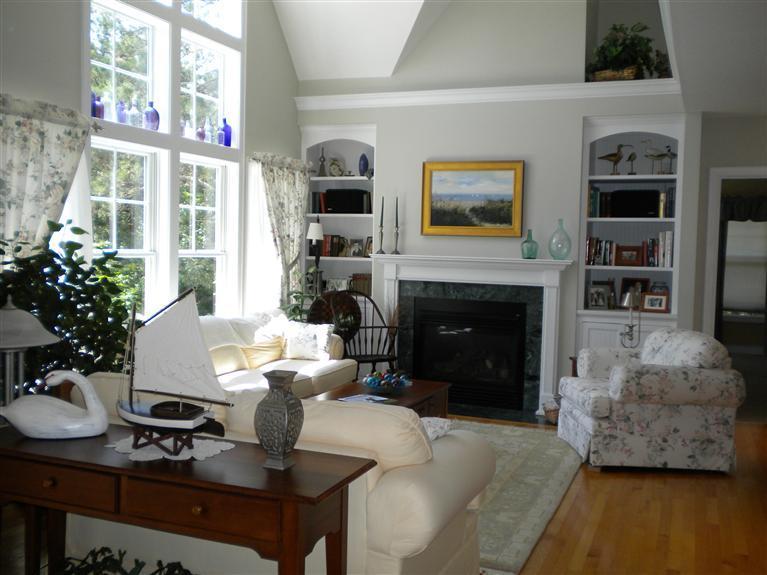 146 Cairn Ridge Road East Falmouth, MA 02536 - Photo 8 of 29 a living room with furniture a fireplace and a flat screen tv