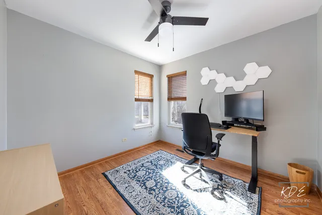 a living room with furniture a flat screen tv and a window