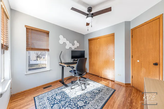 a workspace with wooden floor and a window