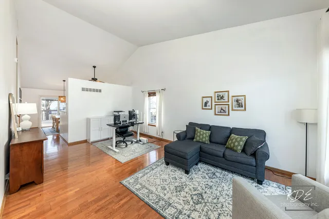 a living room with furniture and wooden floor