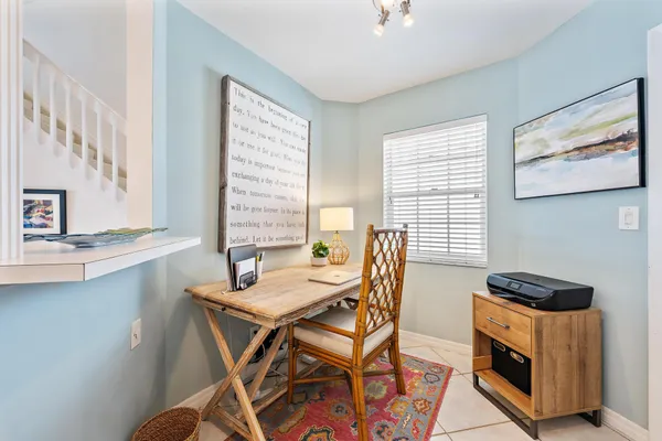 a dining room with a wooden table and chairs