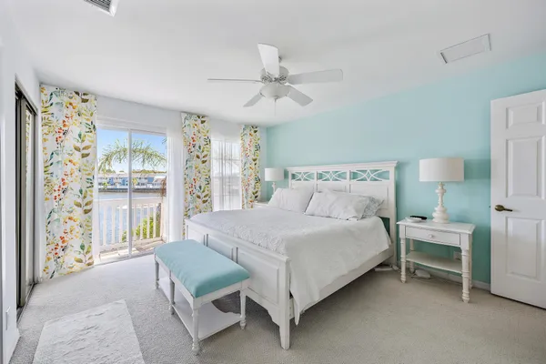a bedroom with a bed wooden floor and window