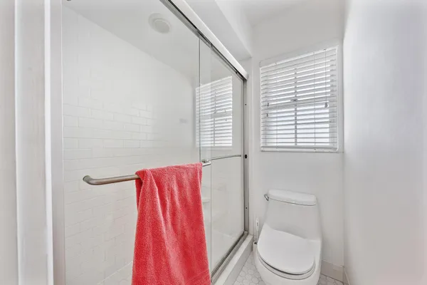 a bathroom with a toilet and a shower curtain