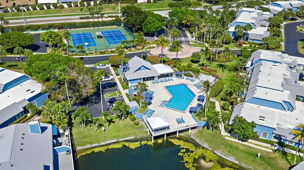 an aerial view of a house with a garden potted plants and large trees