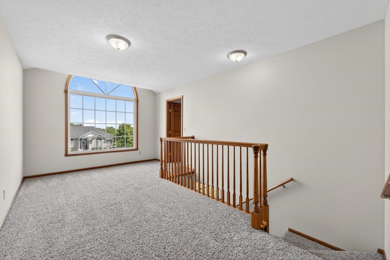 676 Elberon Way Roscoe, IL 61073 - Photo 16 of 30 a view of an empty room with a window and a ceiling fan