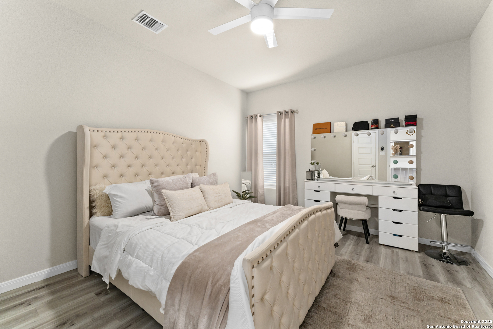 16851 Griffin Road, Unit 2 Atascosa, TX 78002 - Photo 12 of 37 a bedroom with a bed and a chandelier