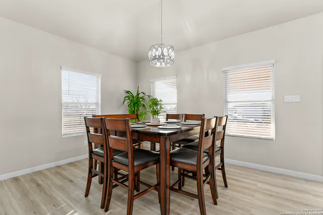 a living room with furniture a flat screen tv and wooden floor