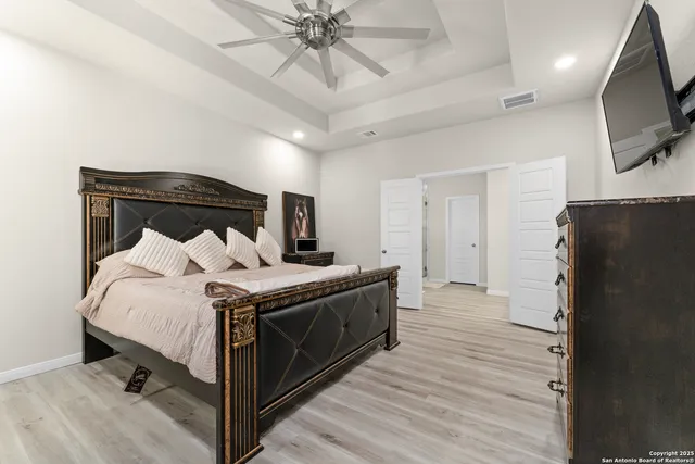 a bed room with a bed and a television