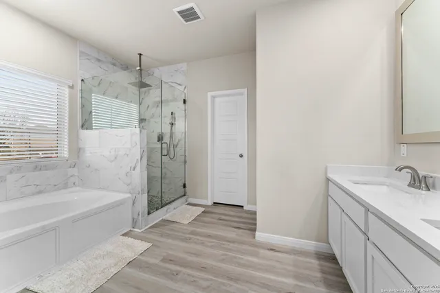 a bathroom with a bathtub and shower
