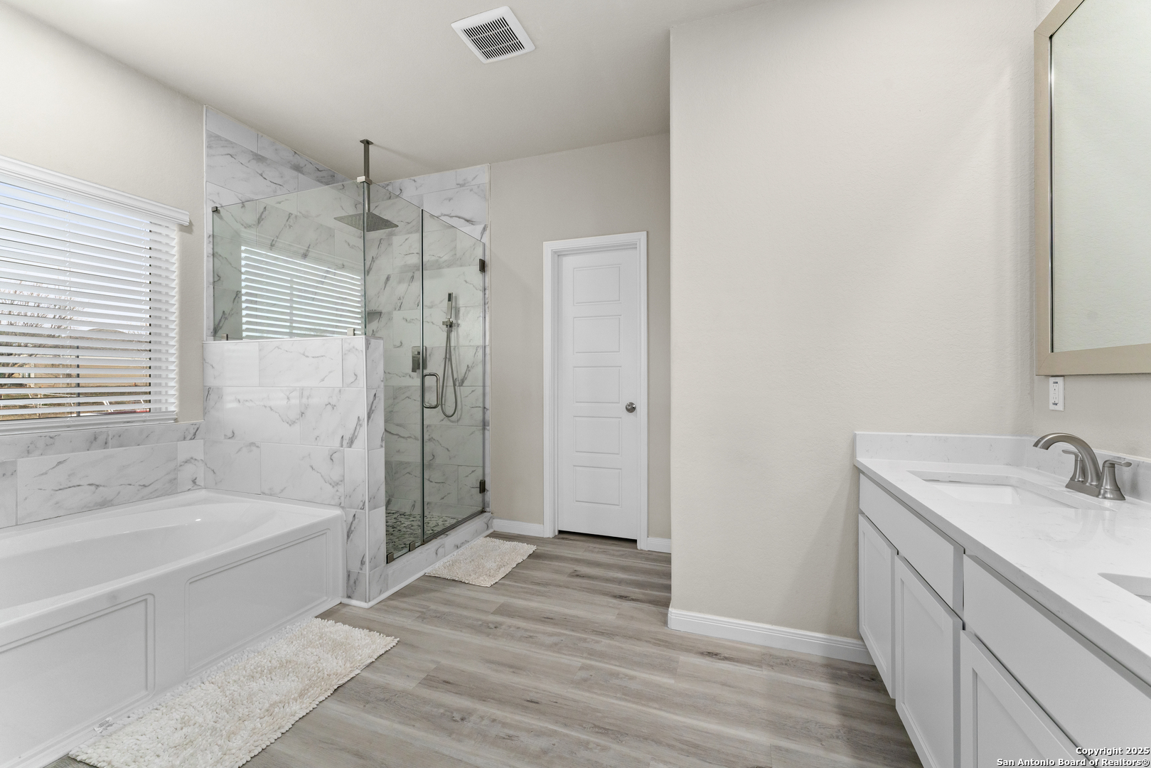 16851 Griffin Road, Unit 2 Atascosa, TX 78002 - Photo 25 of 37 a bathroom with a sink a mirror and a bathtub