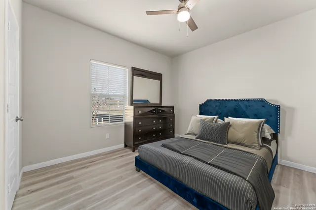 a bathroom with a sink a toilet and shower curtain