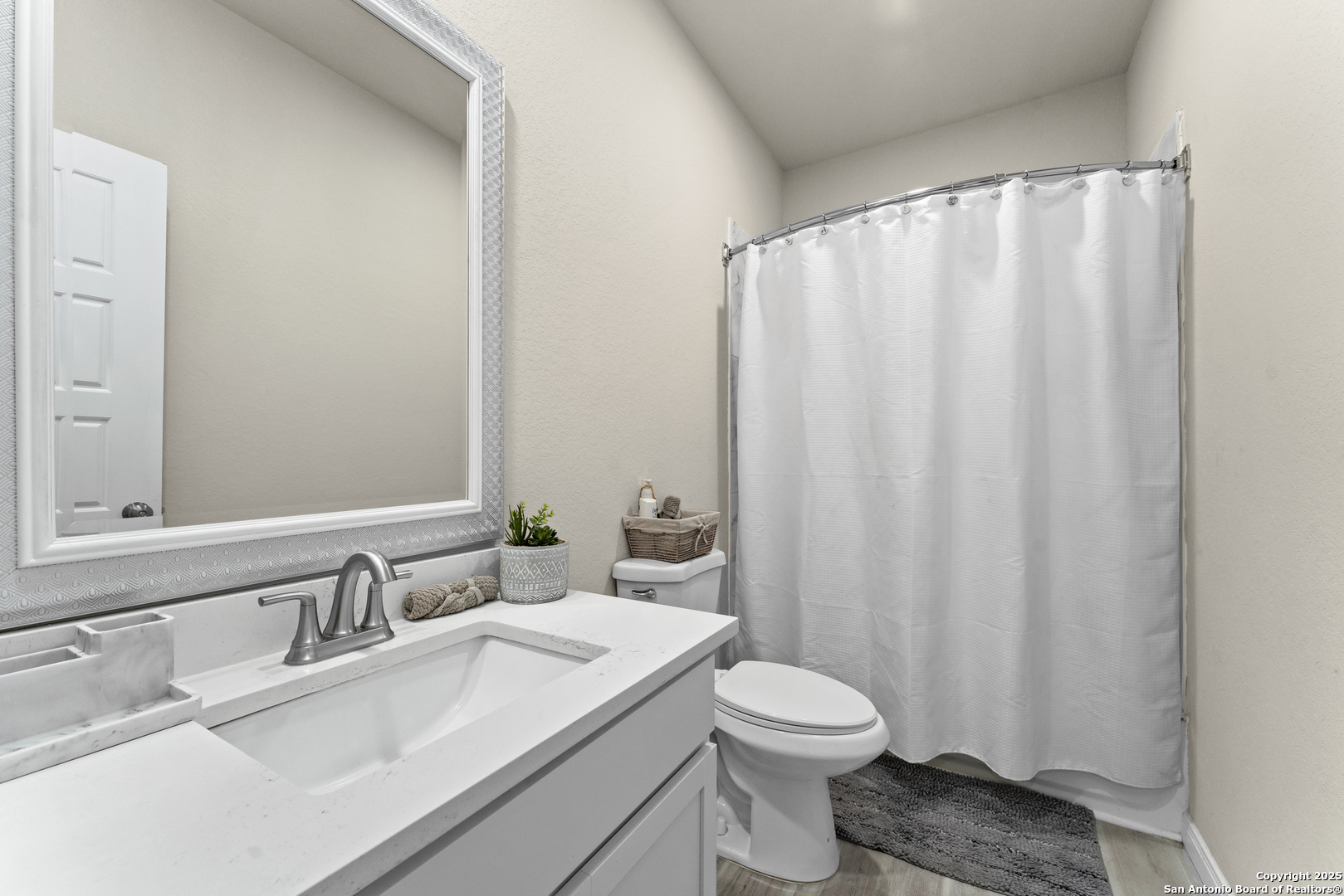 16851 Griffin Road, Unit 2 Atascosa, TX 78002 - Photo 9 of 37 a bathroom with a sink a toilet and shower curtain