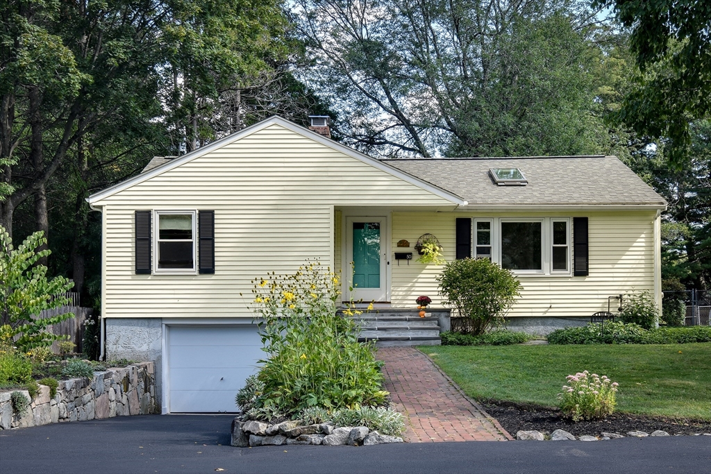 a view of a house with a yard and plants