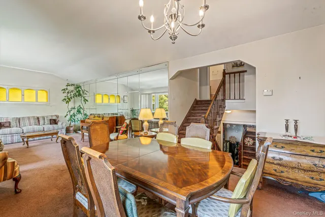 a dining room with furniture and chandelier