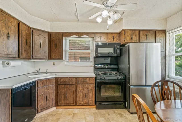 a kitchen with stainless steel appliances a stove a sink and a refrigerator