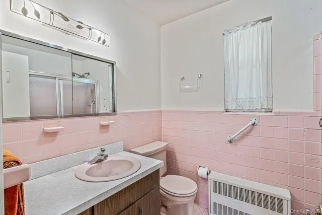 a bathroom with a sink vanity granite and toilet