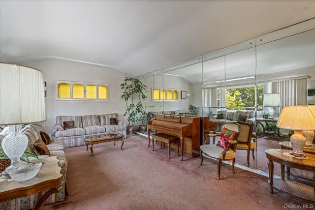a living room filled with furniture and a window