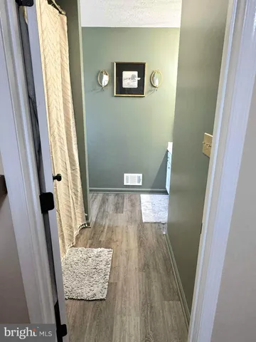 a view of a hallway view with wooden floor and staircase
