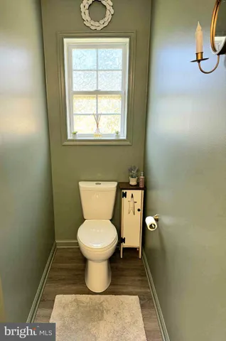 a bathroom with a toilet sink and window