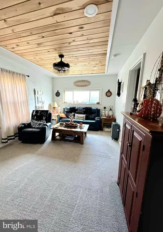a living room with furniture flat screen tv and a window