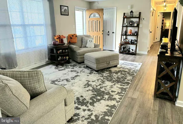 a bedroom with furniture and a wooden floor