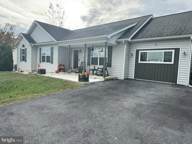 front view of a house with a patio and a yard