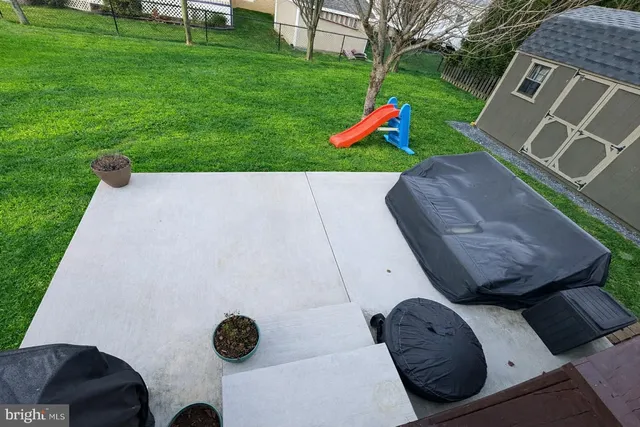a view of backyard with seating space and trees