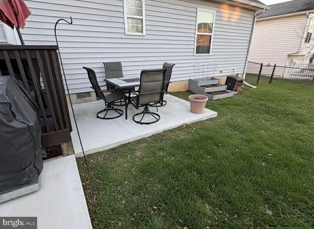 a view of backyard with sitting area