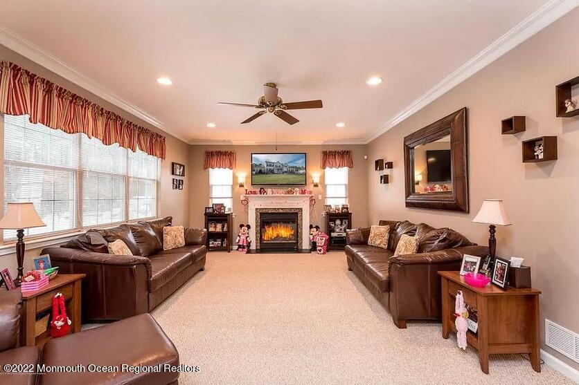 8 Firenze Road Jackson, NJ 08527 - Photo 12 of 23 a living room with furniture fireplace and a large window