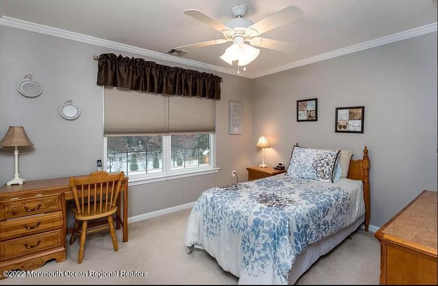 8 Firenze Road Jackson, NJ 08527 - Photo 18 of 23 a bedroom with a bed chairs and a window