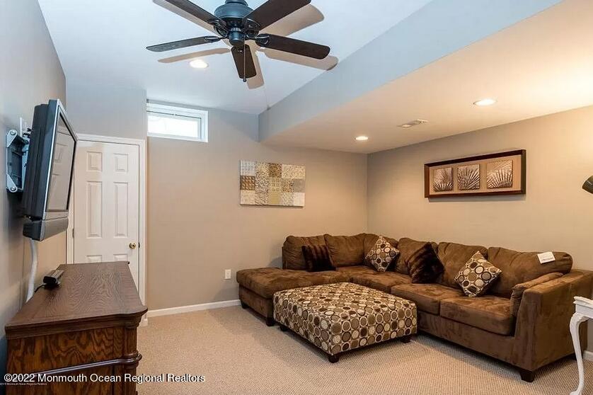 8 Firenze Road Jackson, NJ 08527 - Photo 22 of 23 a living room with furniture and a flat screen tv