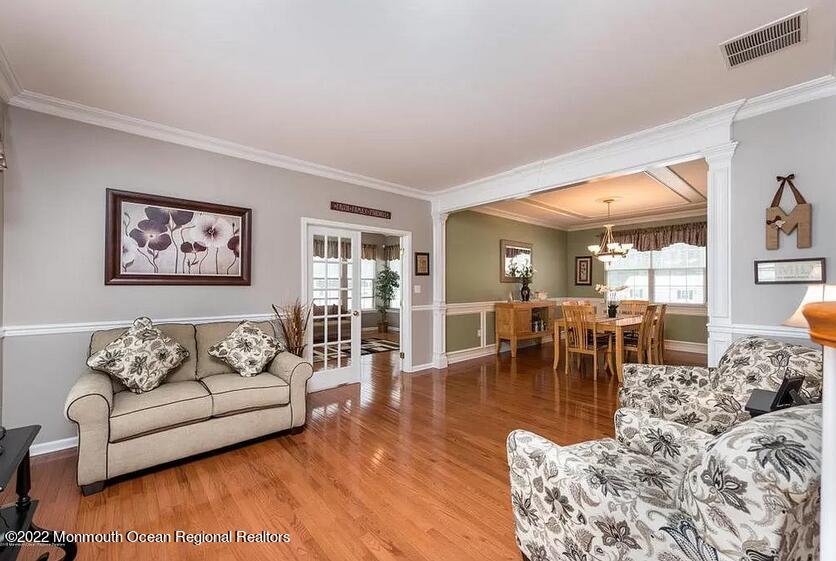8 Firenze Road Jackson, NJ 08527 - Photo 8 of 23 a living room with furniture a rug and a dining table with kitchen view