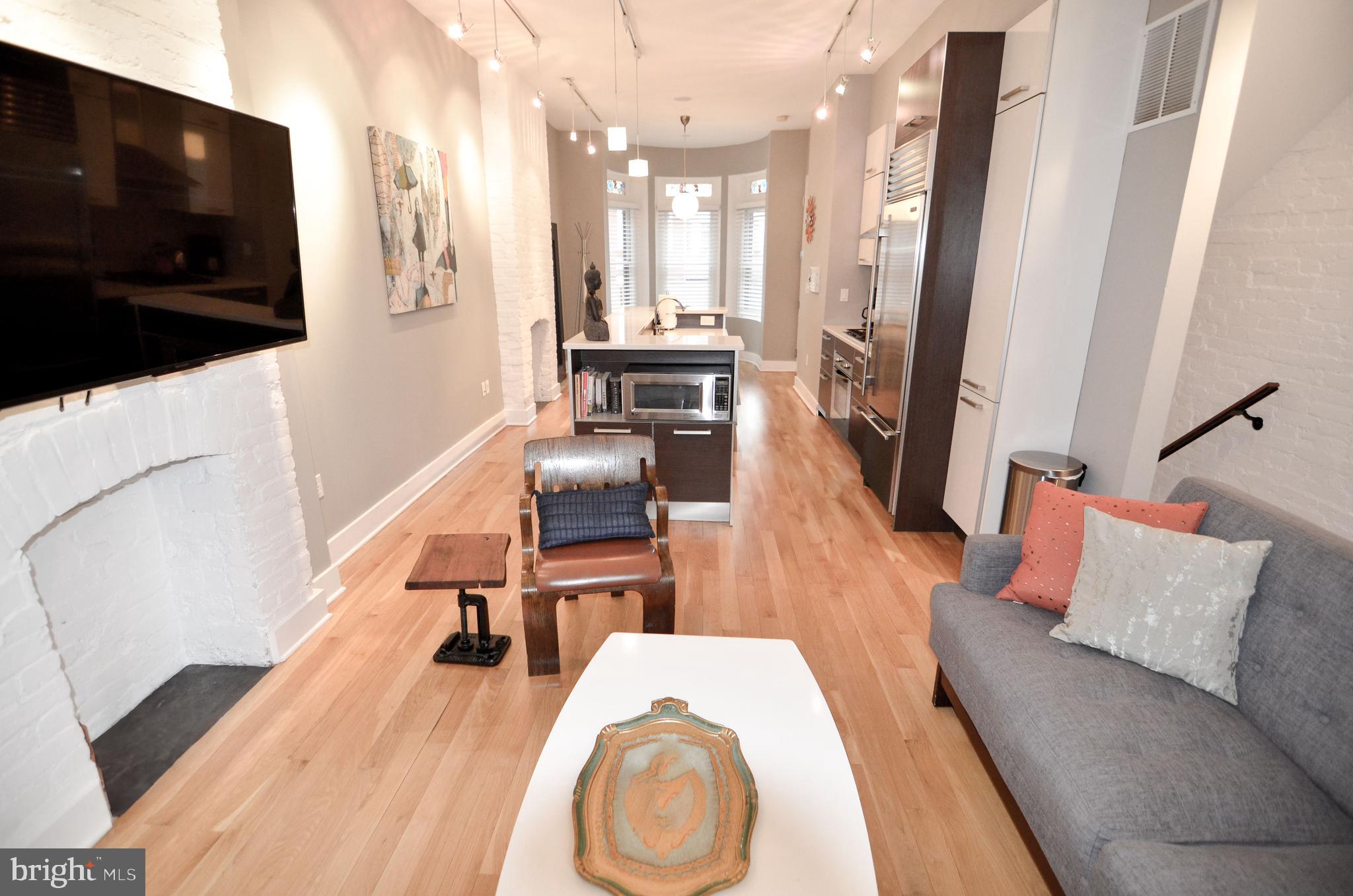1538 Swann Street Northwest Washington, DC 20009 - Photo 16 of 37 Unit 1 - Living Area w/ Exposed Brick Hearth