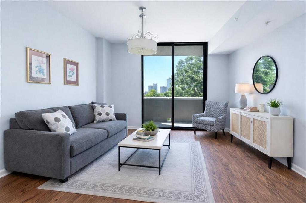 a living room with furniture and a wooden floor