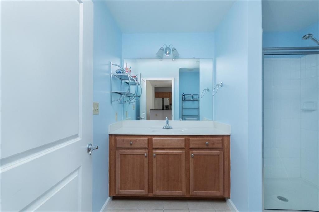 3040 Peachtree Road, Unit 507 Atlanta, GA 30305 - Photo 13 of 33 a spacious bathroom with a double vanity sink and a mirror