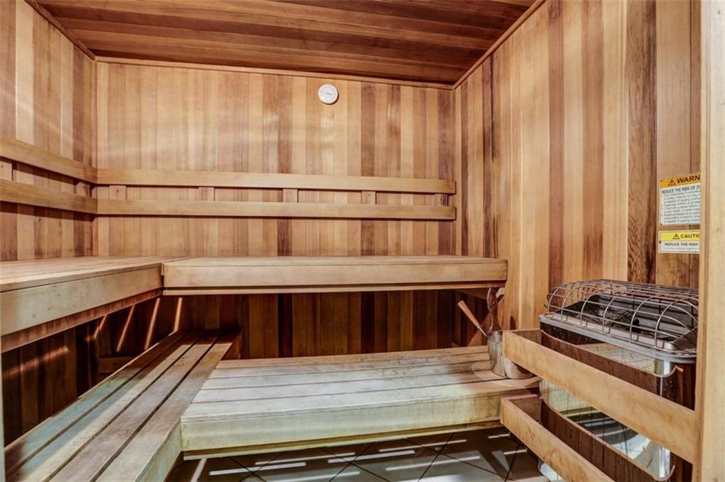 3040 Peachtree Road, Unit 507 Atlanta, GA 30305 - Photo 23 of 33 a view of a kitchen with wooden floor and a stove top oven