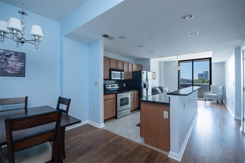 3040 Peachtree Road, Unit 507 Atlanta, GA 30305 - Photo 4 of 33 a kitchen with a table and chairs in it