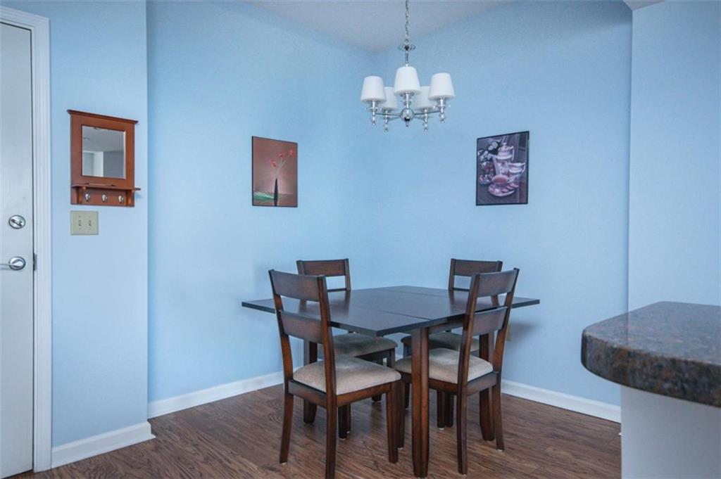 3040 Peachtree Road, Unit 507 Atlanta, GA 30305 - Photo 5 of 33 a view of a dining room with furniture and wooden floor