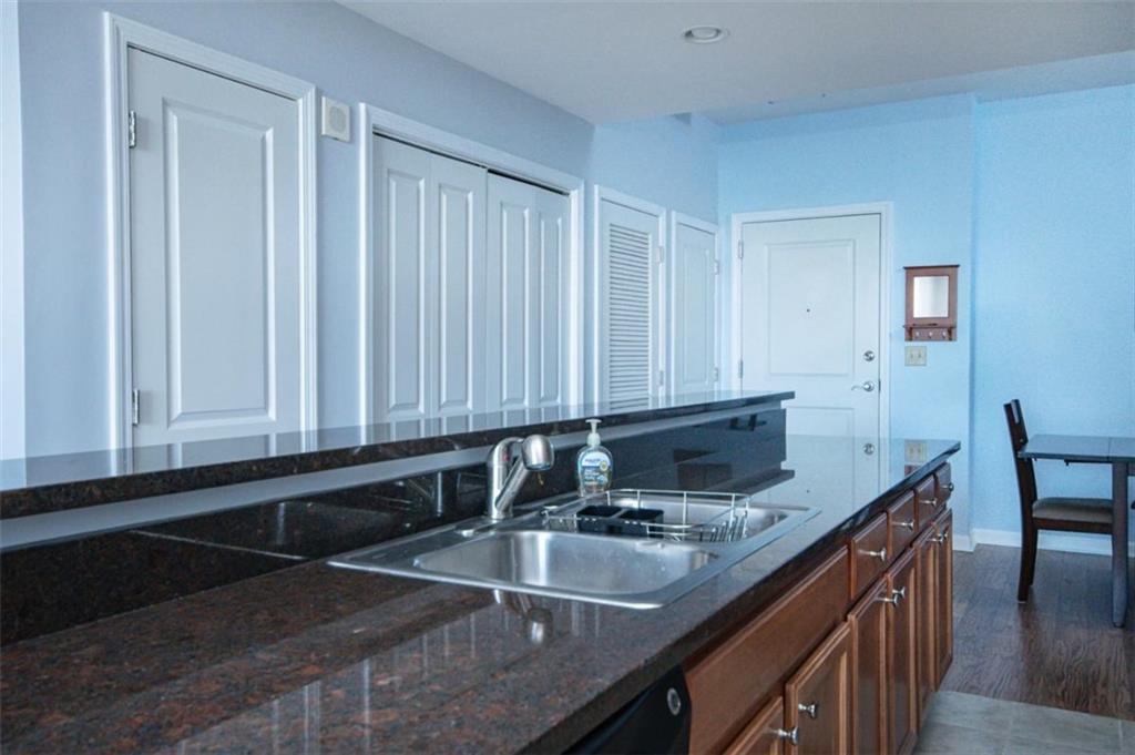 3040 Peachtree Road, Unit 507 Atlanta, GA 30305 - Photo 7 of 33 a kitchen with granite countertop a sink a stove and cabinets