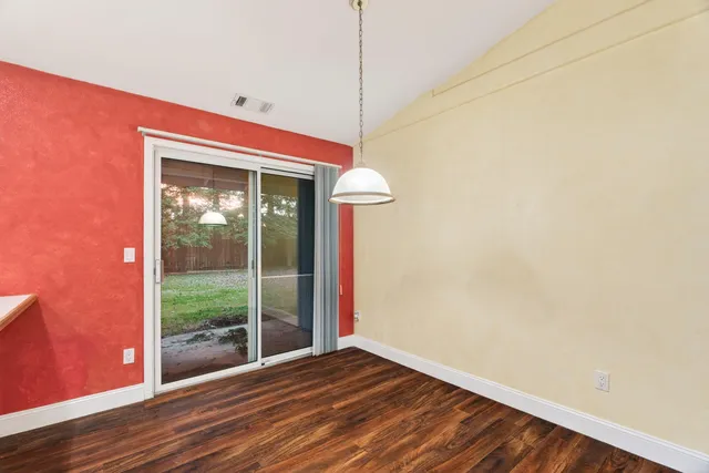 a view of a room with wooden floor and window