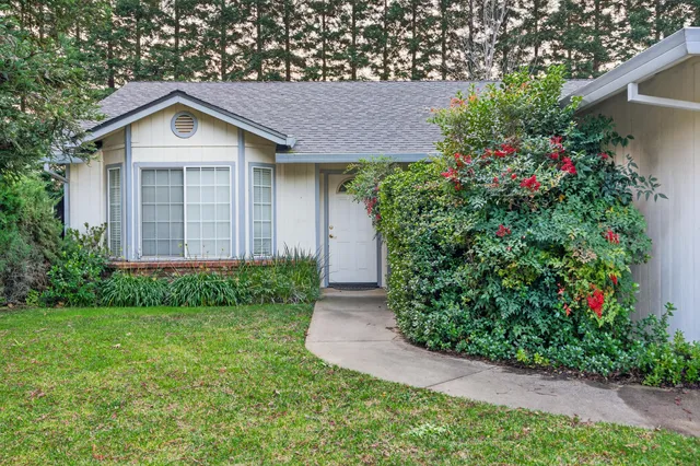 a front view of a house with garden