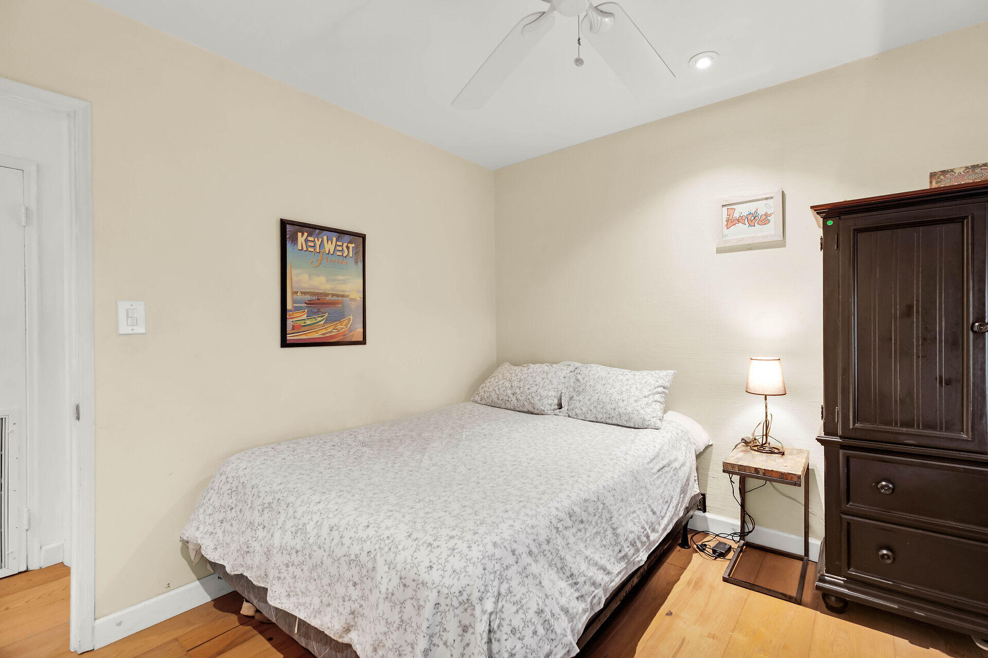 1505 Rose Street Key West, FL 33040 - Photo 29 of 55 a bedroom with a bed and wooden floor