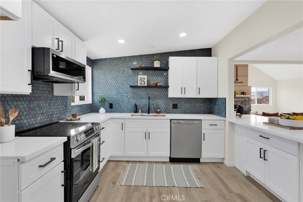 14344 Central Road Apple Valley, CA 92307 - Photo 15 of 61 a kitchen with stainless steel appliances granite countertop a sink and stove top oven